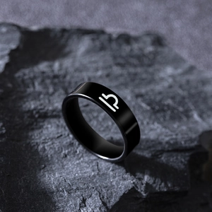 Detail of matte black Libra zodiac sign laser engraved on a stainless steel ring