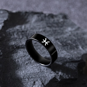 Detailed view of matte black stainless steel ring featuring engraved Pisces zodiac sign