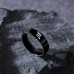 Macro detail of Scorpio zodiac symbol engraved on a black stainless steel ring