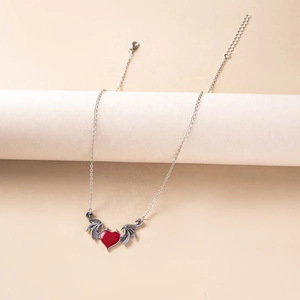 Detailed view of gothic red heart pendant with silver bat wings and adjustable chain