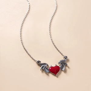 Gothic punk devil wing necklace featuring a red heart pendant on a silver-toned chain