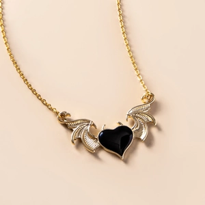 Gothic punk devil wing necklace featuring a black heart pendant in gold finish