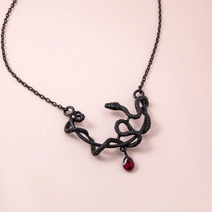 Gothic black snake pendant necklace with red teardrop gemstone on a black fine chain