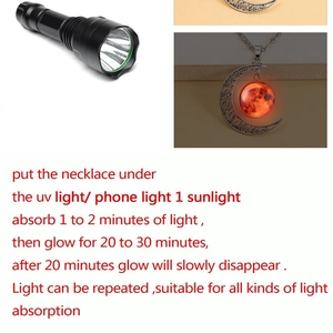 Luminous crescent moon pendant necklace showing glow-in-the-dark effect and details