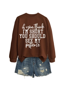 Brown crewneck sweatshirt with slogan and distressed denim shorts two-piece outfit