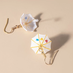 Detail of creative umbrella earrings with colorful hearts and a small faux pearl bead