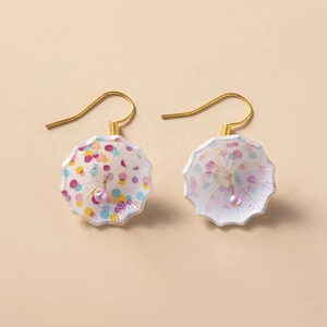 Macro detail of miniature colorful umbrella earrings with gold hooks and polka dots
