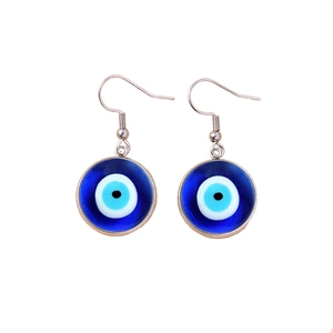 Classic Evil Eye blue resin drop earrings with silver metal hooks on white background