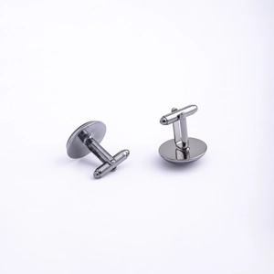 Detail of gunmetal polished round cufflinks with T-bar swivel back for formal business suits