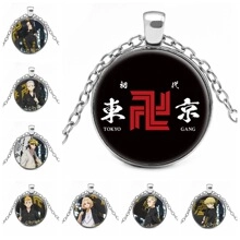 Detail of Tokyo Revengers glass pendant necklace featuring the Tokyo Gang logo and characters
