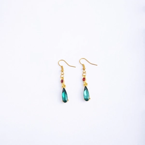 Anime-inspired gold emerald teardrop earrings with red crystal studs on white background