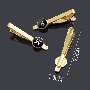 Golden 26 alphabet tie clip set with polished finish and black round initials disc