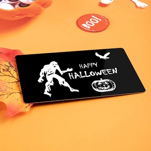 Black Halloween metal wallet card with zombie and pumpkin design on orange background