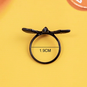 Gothic black bat ring for Halloween with carved wing textures on yellow background