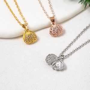 Scallop pendant necklaces in rose gold, silver and gold with pavé diamonds and pearls