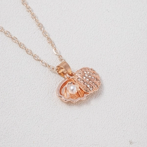 Rose gold seashell necklace with sparkling rhinestones and a white pearl pendant