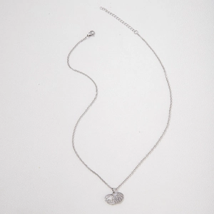 Close-up of shell pendant with white pearl, sparkling crystals and adjustable clasp