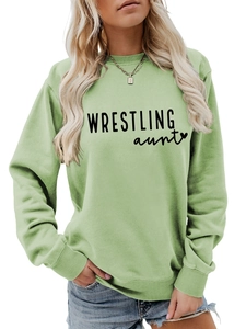 Close-up of light green crewneck sweatshirt with Wrestling Aunt print and heart detail