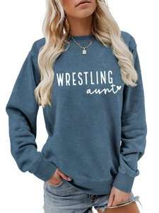 Close-up of WRESTLING aunt print and ribbed cuffs on navy blue crewneck sweatshirt
