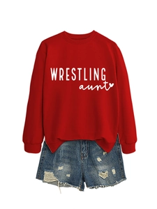 Close-up of red Wrestling Aunt crewneck sweatshirt and blue distressed denim shorts