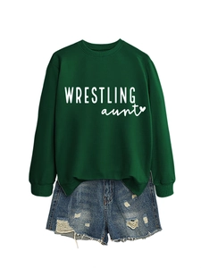 Flat lay of a dark green crewneck sweatshirt and distressed denim shorts with heart graphic
