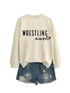 Detail view of beige Wrestling Aunt sweatshirt and distressed denim shorts set
