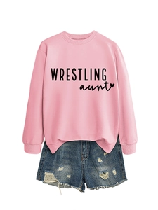Flat lay of pink crewneck sweatshirt with Wrestling Aunt print and ripped denim shorts