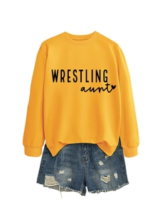 Detailed flat lay of bright yellow crewneck sweatshirt with Wrestling Aunt heart print