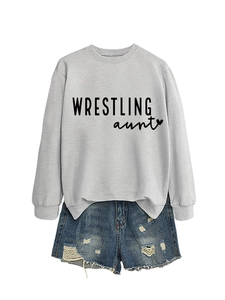 Flat lay of a grey crewneck sweatshirt with Wrestling Aunt print and distressed denim shorts