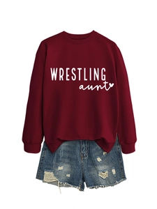 Flat lay of burgundy wrestling aunt sweatshirt paired with distressed denim shorts set