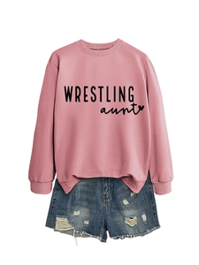 Flat lay of pink 'WRESTLING aunt' sweatshirt with distressed denim shorts detail