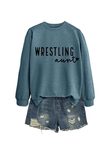 Flat lay detail of a blue crewneck sweatshirt with Wrestling Aunt text and distressed shorts