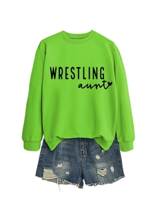 Detail of neon green crewneck sweatshirt with Wrestling Aunt print and denim shorts