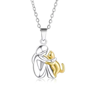 Detail of two-tone girl hugging a cat pendant necklace in silver and gold plating