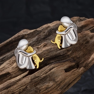 Minimalist girl and dog hugging stud earrings in gold and silver finish on wood