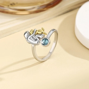 Hugging girl and golden dog ring with blue birthstone in bicolor plated finish