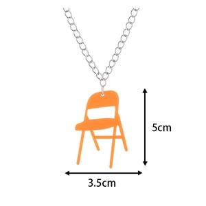 Creative mini orange folding chair pendant necklace with silver chain on white background