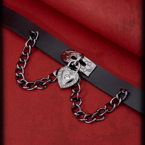 Punk black leather choker featuring a vintage heart locket with chain and crystal detail