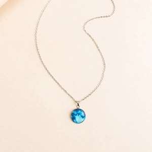 Minimalist luminous blue moon pendant necklace with silver chain and glass dome finish