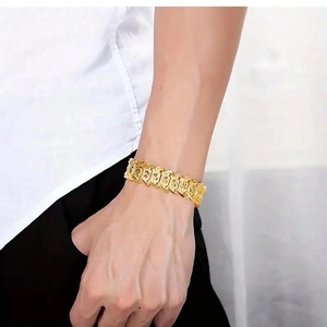 Men's wide rectangular gold-tone bracelet with embossed patterns in a retro hip-hop style