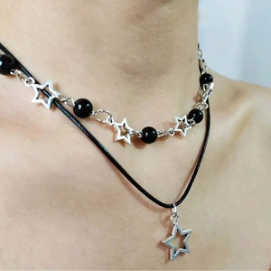 Double-layered punk necklace featuring black beads and silver star pendants on a cord