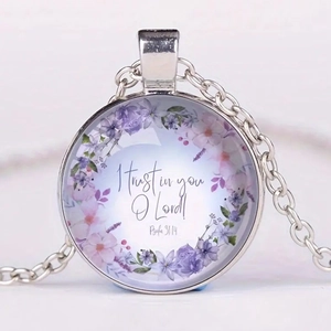 Macro detail of Bible verse Psalm 31:14 printed on a floral glass cabochon pendant