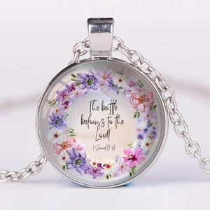 Detail of silver glass pendant necklace featuring religious Bible verse and floral art