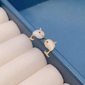 Silver dolphin stud earrings with opal stone inlay on blue leather jewelry box