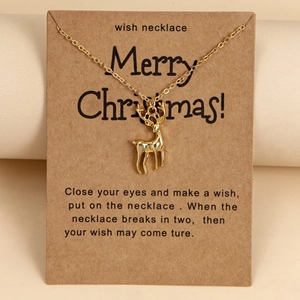 Golden reindeer pendant necklace on brown wish card for Christmas gift