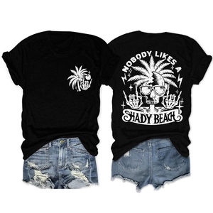 Detail of black T-shirt with 'Nobody likes a shady beach' graphic and denim shorts