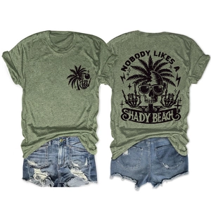 Flat lay of olive green t-shirt with skull beach print and distressed denim shorts