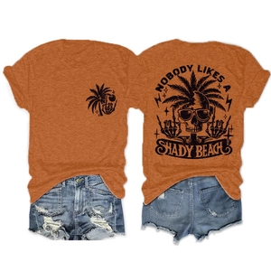Detailed back view of orange cotton t-shirt with tropical skull graphic and denim shorts