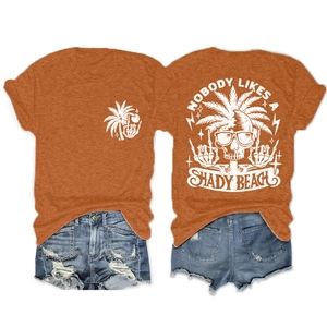 Detailed front and back view of orange t-shirt with shady beach skull print and denim shorts