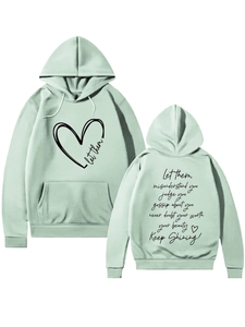 Detail of sage green hoodie with let them lettering and artistic heart print design